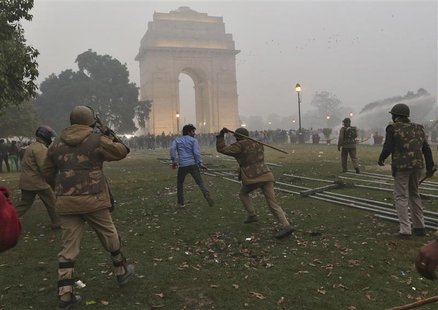 A policeman uses a baton to disperse a demonstrator during a protest in front of India Gate in New Delhi December 23, 2012. REUTERS/Ahmad Ma A policeman uses a baton to disperse a demonstrator during a protest in front of India Gate in New Delhi December 23, 2012. REUTERS/Ahmad Ma