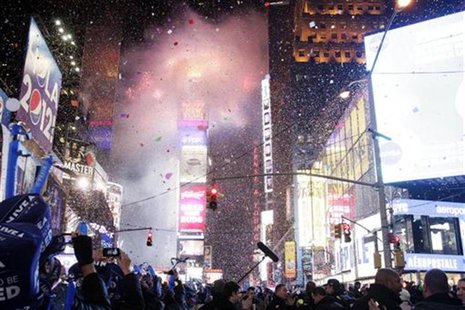 Revellers usher in the new year at midnight during New Year's Eve celebrations at Times Square in New York, January 1, 2012. REUTERS/Kena Be Revellers usher in the new year at midnight during New Year's Eve celebrations at Times Square in New York, January 1, 2012. REUTERS/Kena Be