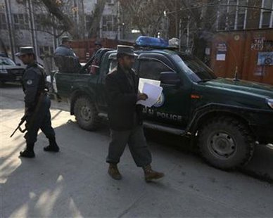 Afghan policemen stand guard at the site of an incident inside the compound where a U.S. advisor was killed in Kabul, December 24, 2012. REUTERS/Omar Sobhani Afghan policemen stand guard at the site of an incident inside the compound where a U.S. advisor was killed in Kabul, December 24, 2012. REUTERS/Omar Sobhani
