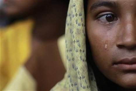 A Muslim woman, displaced by recent violence in Kyukphyu township, cries after arriving at the Thaechaung refugee camp outside of Sittwe in A Muslim woman, displaced by recent violence in Kyukphyu township, cries after arriving at the Thaechaung refugee camp outside of Sittwe in