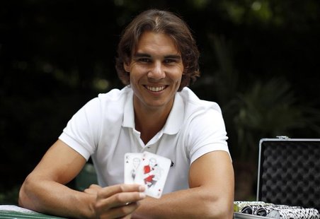 Spanish tennis player Rafael Nadal poses with playing cards depicting some of his 11 Grand Slam victories after an interview with Reuters in Spanish tennis player Rafael Nadal poses with playing cards depicting some of his 11 Grand Slam victories after an interview with Reuters in
