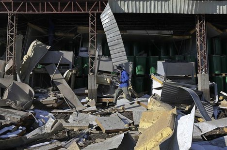An Afghan worker walks among rubbles of a fruit factory which was destroyed by a car suicide bomb attack, in Kabul December 21, 2012. REUTER An Afghan worker walks among rubbles of a fruit factory which was destroyed by a car suicide bomb attack, in Kabul December 21, 2012. REUTER