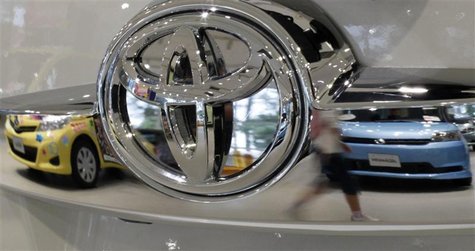 A visitor walking past cars is reflected on a Toyota car at the company's showroom in Tokyo October 18, 2012. REUTERS/Toru Hanai A visitor walking past cars is reflected on a Toyota car at the company's showroom in Tokyo October 18, 2012. REUTERS/Toru Hanai