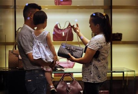 A woman shops for handbags at a Gucci luxury boutique at the IFC Mall in Shanghai June 4, 2012. REUTERS/Carlos Barria A woman shops for handbags at a Gucci luxury boutique at the IFC Mall in Shanghai June 4, 2012. REUTERS/Carlos Barria