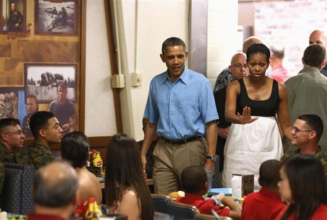 U.S. President Barack Obama and first lady Michelle Obama visit military personnel and their families as they walk into Anderson Hall base c U.S. President Barack Obama and first lady Michelle Obama visit military personnel and their families as they walk into Anderson Hall base c