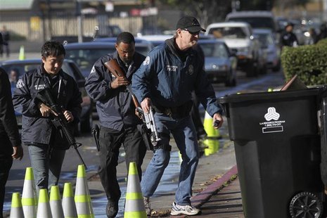 Police officers collect guns from people in their cars at a gun buyback held by the Los Angeles Police Department in Los Angeles, California Police officers collect guns from people in their cars at a gun buyback held by the Los Angeles Police Department in Los Angeles, California