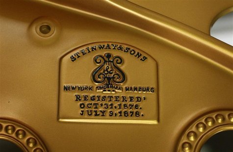 The emblem of a historic Concert Grand piano build on May 11, 1892, is pictured during its refurbishing at the Steinway & Sons factory in Ha The emblem of a historic Concert Grand piano build on May 11, 1892, is pictured during its refurbishing at the Steinway & Sons factory in Ha