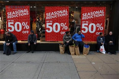 Shoppers rest outside a clothing shop during the Boxing Day sales on Oxford Street in central London, December 26, 2012. REUTERS/Andrew Winn Shoppers rest outside a clothing shop during the Boxing Day sales on Oxford Street in central London, December 26, 2012. REUTERS/Andrew Winn