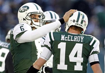 New York Jets quarterback Mark Sanchez pats quarterback Greg McElroy on the helmet after a scoring drive against the San Diego Chargers duri New York Jets quarterback Mark Sanchez pats quarterback Greg McElroy on the helmet after a scoring drive against the San Diego Chargers duri