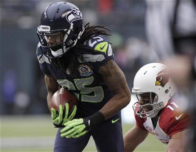 Seattle Seahawks' Richard Sherman (25) intercepts a pass meant for Arizona Cardinals' Larry Fitzgerald (11), returning it for a touchdown du Seattle Seahawks' Richard Sherman (25) intercepts a pass meant for Arizona Cardinals' Larry Fitzgerald (11), returning it for a touchdown du