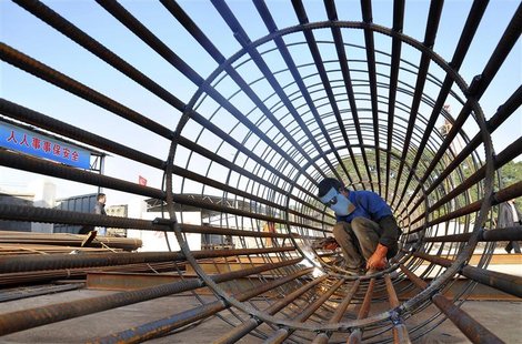 A worker welds steel bars at a construction site for a new train station in Ningbo, Zhejiang province, December 6, 2012. REUTERS/China Daily A worker welds steel bars at a construction site for a new train station in Ningbo, Zhejiang province, December 6, 2012. REUTERS/China Daily