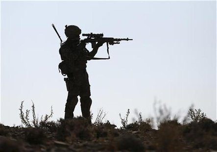A U.S. soldier of B Troop, 1st squadron of 4th US Cavalry Regiment, observes the area with the scope of his rifle near COP (Combat outpost) A U.S. soldier of B Troop, 1st squadron of 4th US Cavalry Regiment, observes the area with the scope of his rifle near COP (Combat outpost)