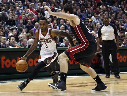 Milwaukee Bucks guard Brandon Jennings (L) drives to the basket against Miami Heat center Josh Harrellson in the second half of their NBA ba Milwaukee Bucks guard Brandon Jennings (L) drives to the basket against Miami Heat center Josh Harrellson in the second half of their NBA ba