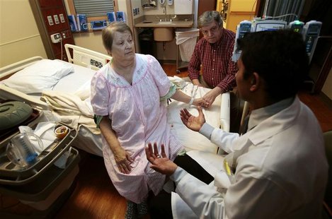Bonita Robbins (L ), a patient suffering with arachnoiditis due to a contaminated steroid injection, sits on her hospital bed as she and her Bonita Robbins (L ), a patient suffering with arachnoiditis due to a contaminated steroid injection, sits on her hospital bed as she and her
