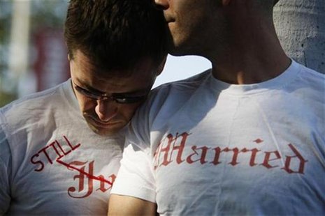 Gay couple Ethan Collings (L), 32, and his spouse Stephen Abate, 36, hug as they celebrate their one-year wedding anniversary in West Hollyw Gay couple Ethan Collings (L), 32, and his spouse Stephen Abate, 36, hug as they celebrate their one-year wedding anniversary in West Hollyw