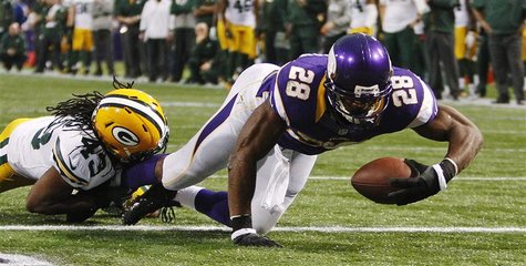 Minnesota Vikings running back Adrian Peterson (28) scores a touchdown past Green Bay Packers safety M.D. Jennings on a seven-yard carry in Minnesota Vikings running back Adrian Peterson (28) scores a touchdown past Green Bay Packers safety M.D. Jennings on a seven-yard carry in