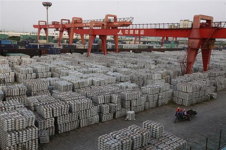 Workers ride on an motor rickshaw through an aluminium ingots depot in Wuxi, Jiangsu province September 26, 2012. REUTERS/Aly Song Workers ride on an motor rickshaw through an aluminium ingots depot in Wuxi, Jiangsu province September 26, 2012. REUTERS/Aly Song