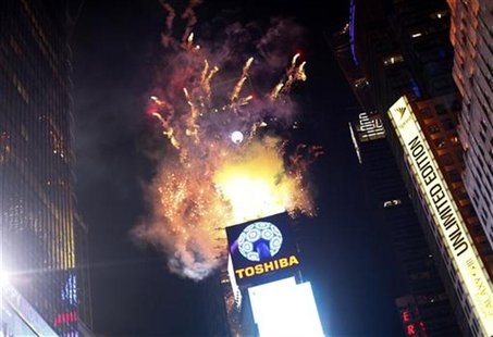 Fireworks explode over Times Square as the crystal ball is hoisted before New Year celebrations in New York December 31, 2012. REUTERS/Joshu Fireworks explode over Times Square as the crystal ball is hoisted before New Year celebrations in New York December 31, 2012. REUTERS/Joshu