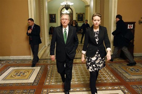 U.S. Senate Minority Leader Mitch McConnell (C) departs the senate floor with an aide after a senate vote in the early morning hours at the U.S. Senate Minority Leader Mitch McConnell (C) departs the senate floor with an aide after a senate vote in the early morning hours at the