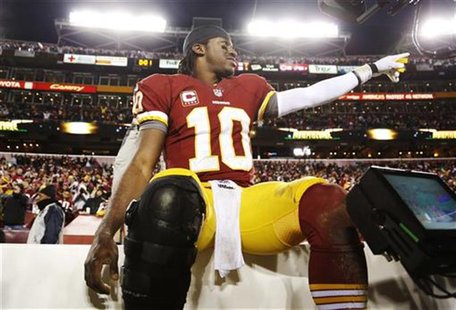 Washington Redskins quarterback Robert Griffin III (10) celebrates on the bench after his team beat the Dallas Cowboys during their NFL foot Washington Redskins quarterback Robert Griffin III (10) celebrates on the bench after his team beat the Dallas Cowboys during their NFL foot