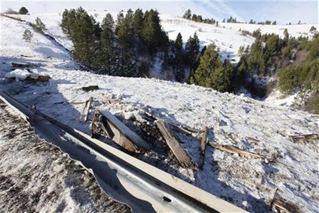 Twisted guard rail and debris line road side where tour bus careened off a mountain highway and plunged down a snow-covered slope, killing n Twisted guard rail and debris line road side where tour bus careened off a mountain highway and plunged down a snow-covered slope, killing n