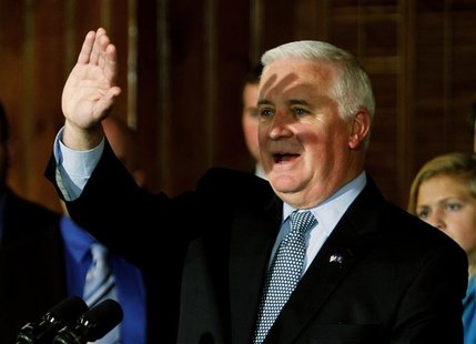 Pennsylvania Governor Tom Corbett shields his eyes during a news conference with a group of Penn State students at the Nittany Lion Inn in S Pennsylvania Governor Tom Corbett shields his eyes during a news conference with a group of Penn State students at the Nittany Lion Inn in S