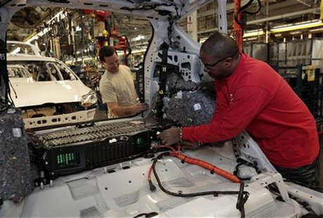 Ford Assembly workers Calvin Thompson (R ) and Jimmie Lackey install a battery in the back of a partially assembled C-MAX Hybrid vehicle at Ford Assembly workers Calvin Thompson (R ) and Jimmie Lackey install a battery in the back of a partially assembled C-MAX Hybrid vehicle at