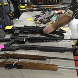 A dealer displays firearms for sale at a gun show in Kansas City, Missouri December 22, 2012. REUTERS/Dave Kaup