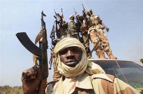Soldiers from the Chadian contingent of the Central African Multinational Force (FOMAC) hold up their weapons in Damara, about 75 km (46 mil Soldiers from the Chadian contingent of the Central African Multinational Force (FOMAC) hold up their weapons in Damara, about 75 km (46 mil
