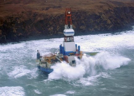 Waves crash over the conical drilling unit Kulluk where it sits aground on the southeast side of Sitkalidak Island, Alaska in this U.S. Coas Waves crash over the conical drilling unit Kulluk where it sits aground on the southeast side of Sitkalidak Island, Alaska in this U.S. Coas