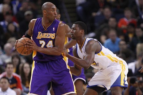 Los Angeles Lakers guard Kobe Bryant (L) looks for an opening as Golden State Warriors Harrison Barnes defends, during the first quarter of Los Angeles Lakers guard Kobe Bryant (L) looks for an opening as Golden State Warriors Harrison Barnes defends, during the first quarter of