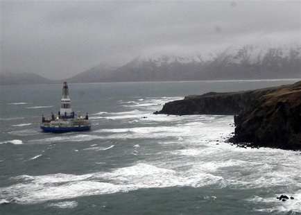 The conical drilling unit Kulluk, owned by Royal Dutch/Shell, sits aground 40 miles (64 kms) southwest of Kodiak City, Alaska, on the shore The conical drilling unit Kulluk, owned by Royal Dutch/Shell, sits aground 40 miles (64 kms) southwest of Kodiak City, Alaska, on the shore