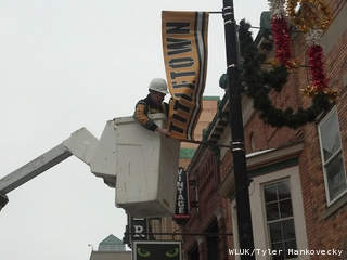 Green Bay Mayor Jim Schmitt hangs a Titletown banner on a downtown street light post Jan. 3, 2013, two days before the Green Bay Packers host the Minnesota Vikings in a Wild Card NFL playoff game. (courtesy of FOX 11). Green Bay Mayor Jim Schmitt hangs a Titletown banner on a downtown street light post Jan. 3, 2013, two days before the Green Bay Packers host the Minnesota Vikings in a Wild Card NFL playoff game. (courtesy of FOX 11).
