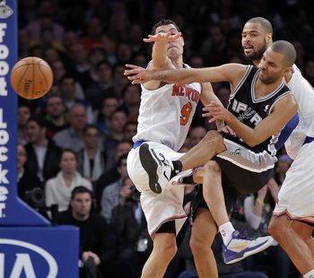 San Antonio Spurs guard Tony Parker (C) slams into New York Knicks guard Pablo Prigioni (L) as he passes in the first quarter of their NBA b San Antonio Spurs guard Tony Parker (C) slams into New York Knicks guard Pablo Prigioni (L) as he passes in the first quarter of their NBA b