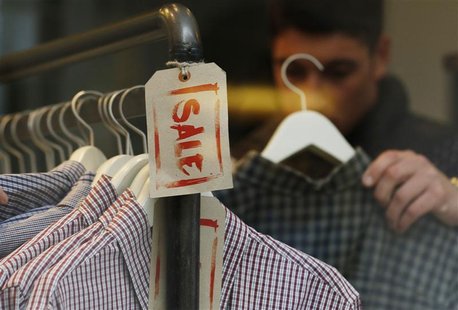 A man looks at clothes on a Sale rail inside a shop during the Christmas sales in London December 27, 2012. REUTERS/Luke MacGregor A man looks at clothes on a Sale rail inside a shop during the Christmas sales in London December 27, 2012. REUTERS/Luke MacGregor