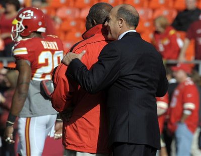 Kansas City Chiefs head coach Romeo Crennel (L) is hugged by general manager Scott Pioli before the start of their NFL game against the Caro Kansas City Chiefs head coach Romeo Crennel (L) is hugged by general manager Scott Pioli before the start of their NFL game against the Caro