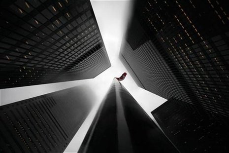 The Canadian flag is seen on top of a flagpole in the midst of high-rise buildings in the financial district of Toronto April 3, 2009. REUTE The Canadian flag is seen on top of a flagpole in the midst of high-rise buildings in the financial district of Toronto April 3, 2009. REUTE