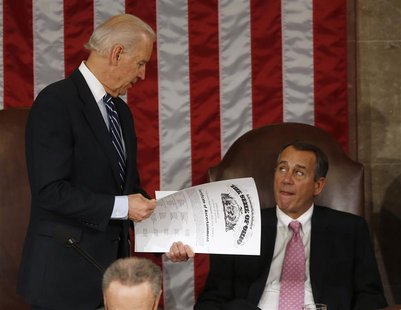 U.S. Vice President Joe Biden (L) holds the presidential election electoral college vote certificate representing the state of Ohio alongsid U.S. Vice President Joe Biden (L) holds the presidential election electoral college vote certificate representing the state of Ohio alongsid