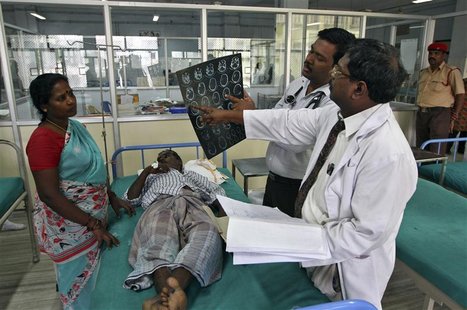 Doctors examine a magnetic resonance imaging (MRI) scan of a patient lying on a bed inside a ward at Rajiv Gandhi Government General Hospita Doctors examine a magnetic resonance imaging (MRI) scan of a patient lying on a bed inside a ward at Rajiv Gandhi Government General Hospita