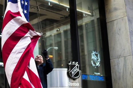 A worker lowers the U.S. flag outside of NHL headquarters in New York, January 2, 2013. REUTERS/Lucas Jackson A worker lowers the U.S. flag outside of NHL headquarters in New York, January 2, 2013. REUTERS/Lucas Jackson