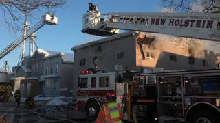 Fire crews battle blaze at apartment building on Railroad Street in New Holstein on Friday January 4, 2012. (courtesy of FOX 11). Fire crews battle blaze at apartment building on Railroad Street in New Holstein on Friday January 4, 2012. (courtesy of FOX 11).
