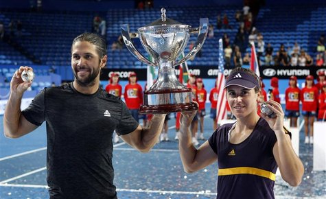 Fernando Verdasco (L) and Anabel Medina Garrigues of Spain hold up the Hopman Cup and their diamond encrusted silver tennis balls after defe Fernando Verdasco (L) and Anabel Medina Garrigues of Spain hold up the Hopman Cup and their diamond encrusted silver tennis balls after defe