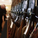A man looks at a shotgun during the East Coast Fine Arms Show in Stamford, Connecticut, January 5, 2013. The show is being held despite the A man looks at a shotgun during the East Coast Fine Arms Show in Stamford, Connecticut, January 5, 2013. The show is being held despite the