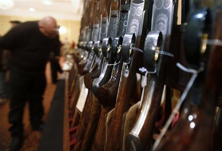 A man looks at a shotgun during the East Coast Fine Arms Show in Stamford, Connecticut, January 5, 2013. The show is being held despite the A man looks at a shotgun during the East Coast Fine Arms Show in Stamford, Connecticut, January 5, 2013. The show is being held despite the
