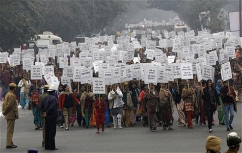 Women hold placards as they march during a rally organized by Delhi Chief Minister Sheila Dikshit (unseen) protesting for justice and securi Women hold placards as they march during a rally organized by Delhi Chief Minister Sheila Dikshit (unseen) protesting for justice and securi
