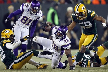 Minnesota Vikings running back Adrian Peterson (28) is brought down by Green Bay Packers inside linebacker Brad Jones (59) during their NFL Minnesota Vikings running back Adrian Peterson (28) is brought down by Green Bay Packers inside linebacker Brad Jones (59) during their NFL