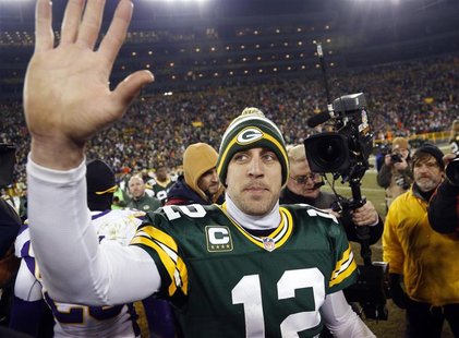 Green Bay Packers quarterback Aaron Rodgers (12) waves to fans after defeating the Minnesota Vikings in their NFL NFC wildcard playoff footb Green Bay Packers quarterback Aaron Rodgers (12) waves to fans after defeating the Minnesota Vikings in their NFL NFC wildcard playoff footb