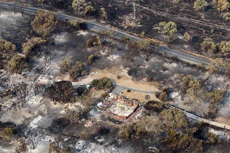 The debris of houses destroyed by a bushfire is seen in Dunalley, about 40 kilometres (25 miles) east of Hobart, January 5, 2013. REUTERS/Ch The debris of houses destroyed by a bushfire is seen in Dunalley, about 40 kilometres (25 miles) east of Hobart, January 5, 2013. REUTERS/Ch