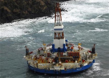 The conical drilling unit Kulluk sits grounded 40 miles (64 kms) southwest of Kodiak City, Alaska in this U.S. Coast Guard handout photo tak The conical drilling unit Kulluk sits grounded 40 miles (64 kms) southwest of Kodiak City, Alaska in this U.S. Coast Guard handout photo tak