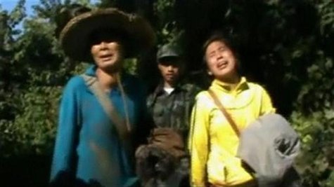 Evacuees react after being received by Kachin's soldiers in Kachin state in this still image taken from a video dated December 28, 2012. REU Evacuees react after being received by Kachin's soldiers in Kachin state in this still image taken from a video dated December 28, 2012. REU
